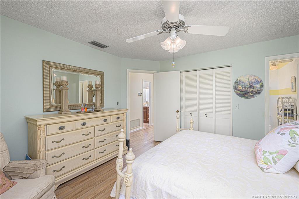 2929 Southeast Ocean Boulevard, Unit 1436 Stuart, FL 34996 - Photo 12 of 18 a bedroom with a bed and a dresser