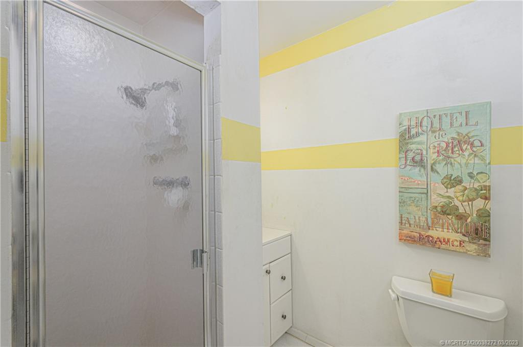 2929 Southeast Ocean Boulevard, Unit 1436 Stuart, FL 34996 - Photo 13 of 18 a bathroom with a shower and a toilet