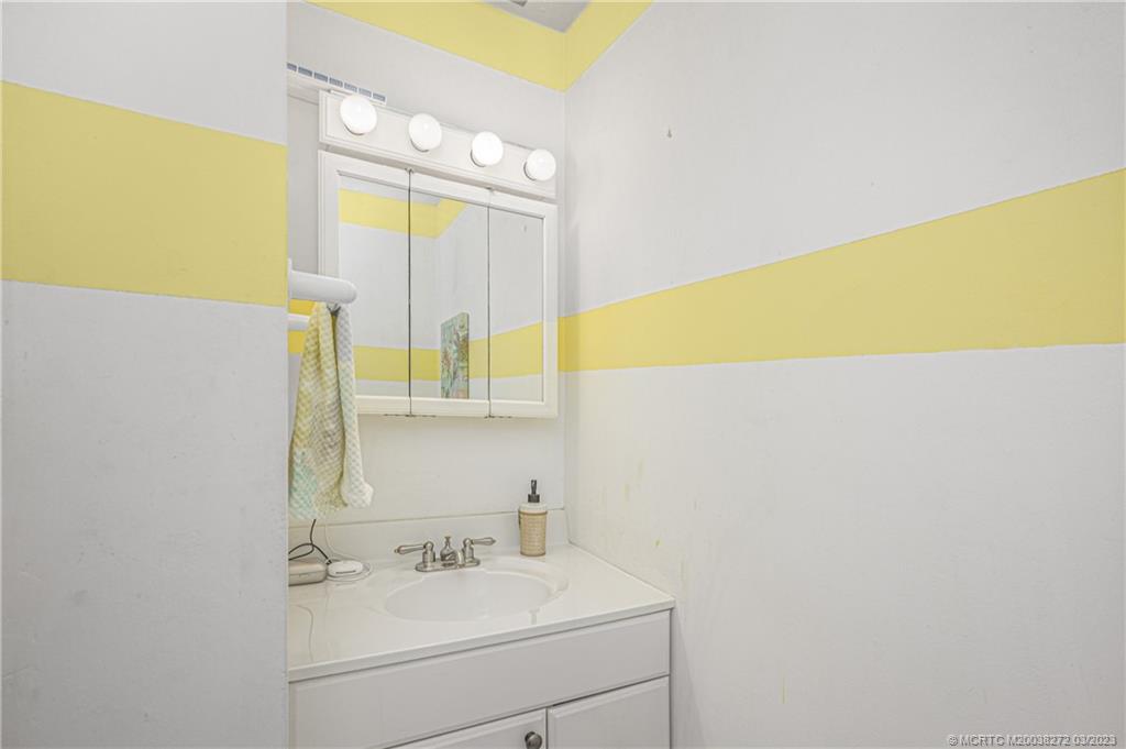 2929 Southeast Ocean Boulevard, Unit 1436 Stuart, FL 34996 - Photo 14 of 18 a bathroom with a sink and a mirror