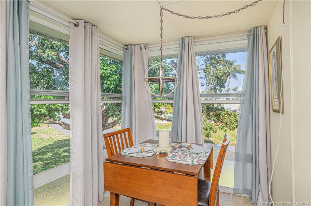 2929 Southeast Ocean Boulevard, Unit 1436 Stuart, FL 34996 - Photo 16 of 18 a view of a dining room with furniture window and outside view