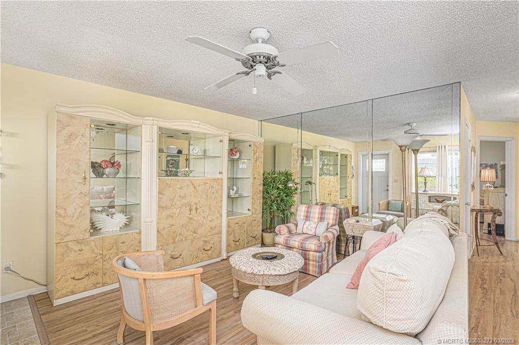 2929 Southeast Ocean Boulevard, Unit 1436 Stuart, FL 34996 - Photo 3 of 18 a living room with furniture and a large window