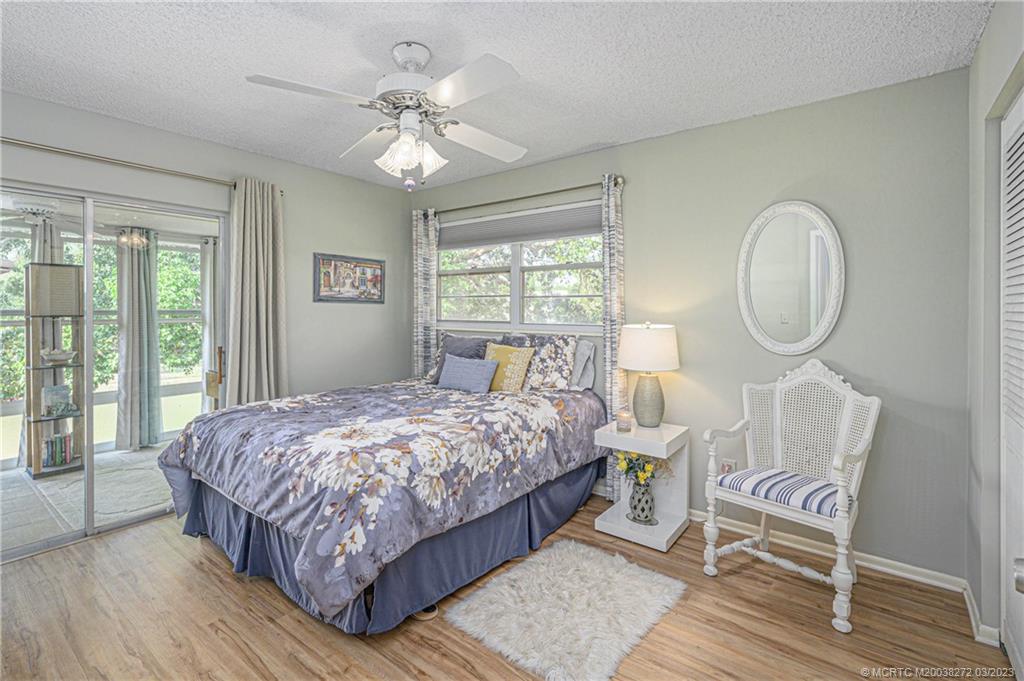 2929 Southeast Ocean Boulevard, Unit 1436 Stuart, FL 34996 - Photo 9 of 18 a bedroom with a bed a window and a chandelier
