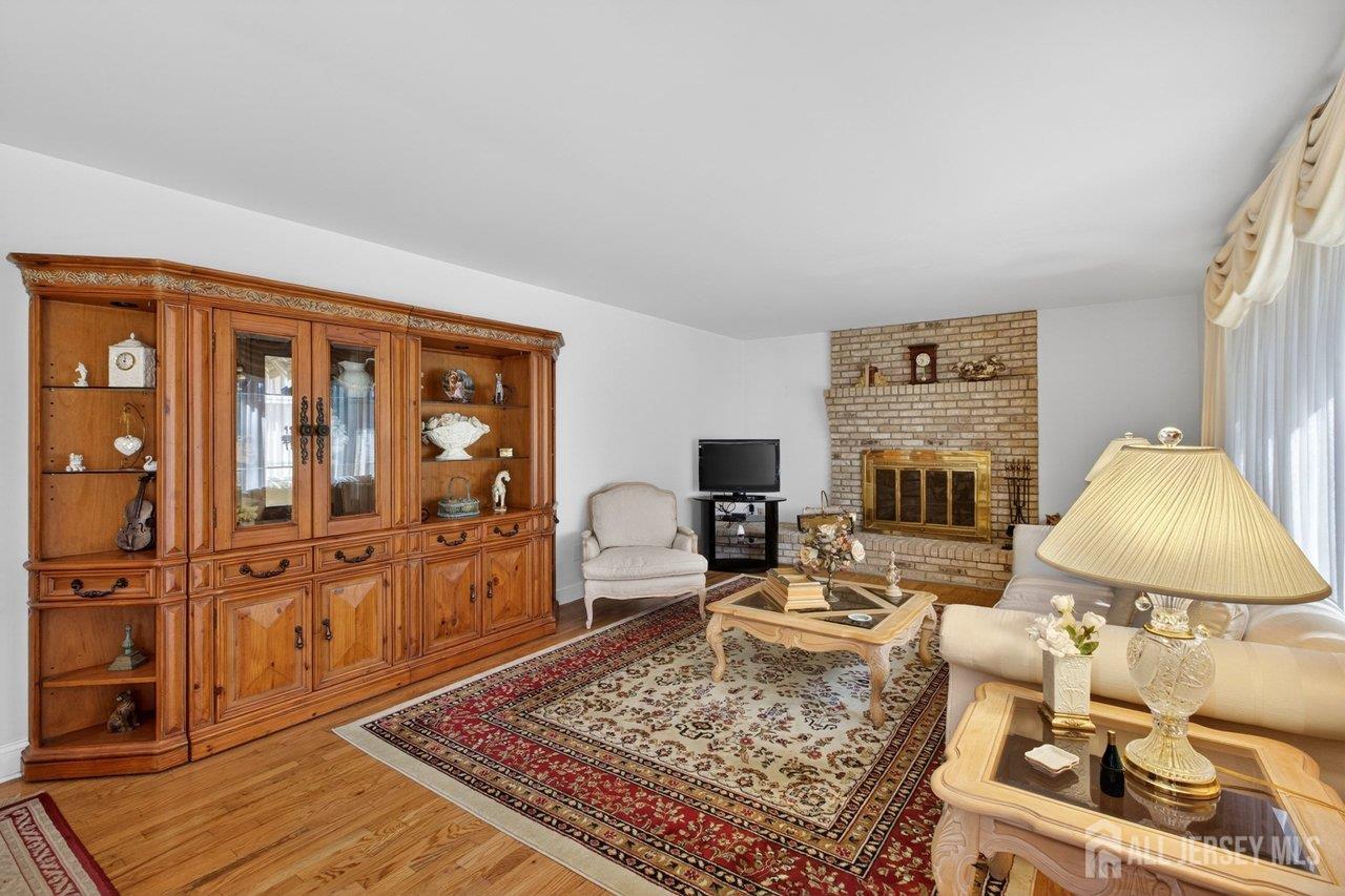 15 Cherokee Road East Brunswick, NJ 08816 - Photo 12 of 45 a living room with furniture and a table