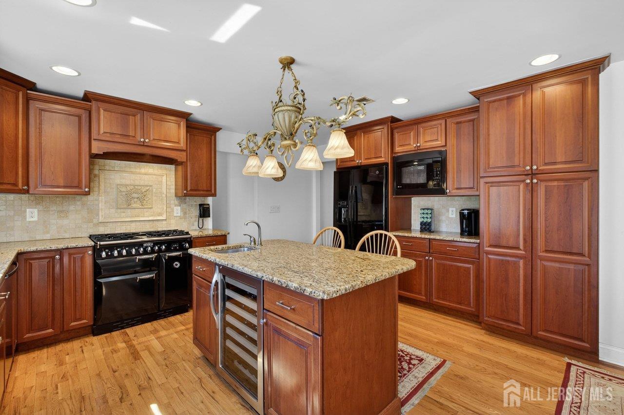 15 Cherokee Road East Brunswick, NJ 08816 - Photo 15 of 45 a kitchen with stainless steel appliances granite countertop a sink stove and refrigerator