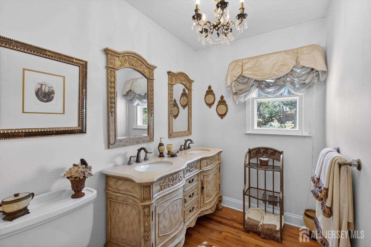 15 Cherokee Road East Brunswick, NJ 08816 - Photo 17 of 45 a bathroom with double vanity sinks a mirror and a window