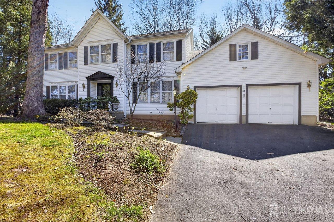 15 Cherokee Road East Brunswick, NJ 08816 - Photo 2 of 45 a front view of a house with a yard and garage