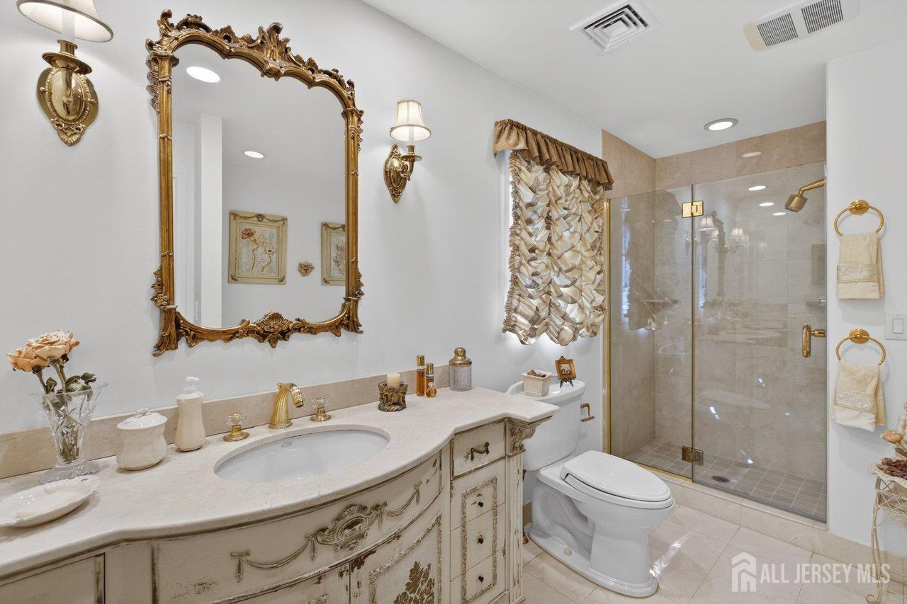 15 Cherokee Road East Brunswick, NJ 08816 - Photo 25 of 45 a bathroom with a sink toilet tub and shower