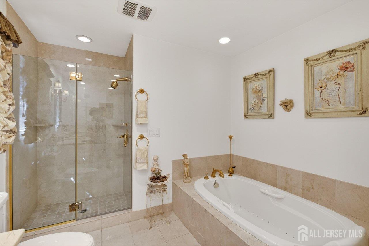15 Cherokee Road East Brunswick, NJ 08816 - Photo 26 of 45 a bathroom with a tub a toilet and a shower