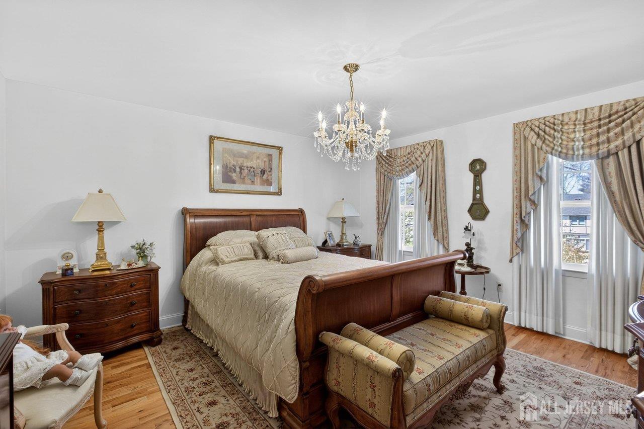 15 Cherokee Road East Brunswick, NJ 08816 - Photo 28 of 45 a spacious bedroom with a bed and wooden floor