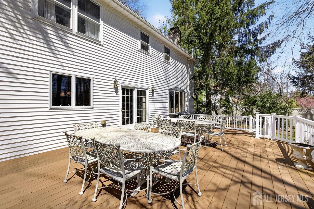 15 Cherokee Road East Brunswick, NJ 08816 - Photo 38 of 45 a view of a patio with table and chairs and wooden floor