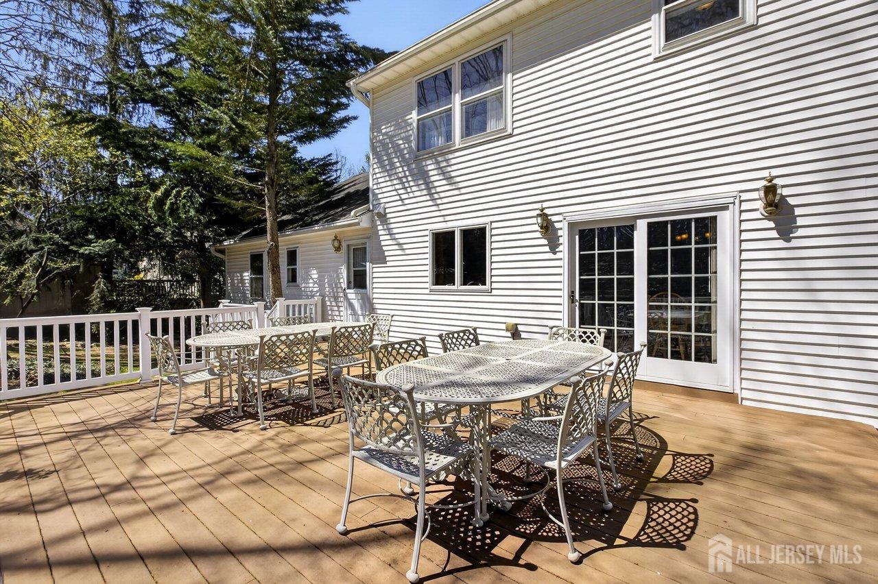 15 Cherokee Road East Brunswick, NJ 08816 - Photo 39 of 45 a patio with table and chairs and potted plants