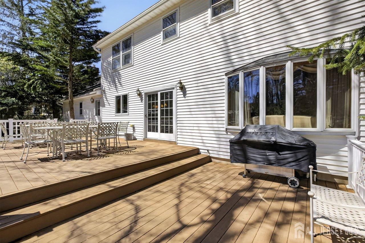 15 Cherokee Road East Brunswick, NJ 08816 - Photo 40 of 45 a front view of a house with barbeque and wooden floor