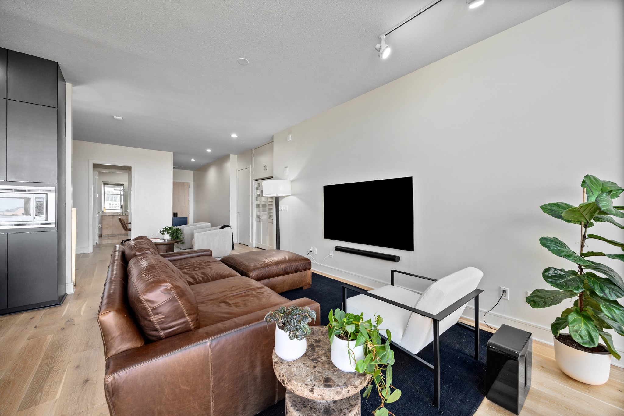 555 East 5th Street, Unit 521 Austin, TX 78701 - Photo 15 of 37 a living room with furniture and a flat screen tv