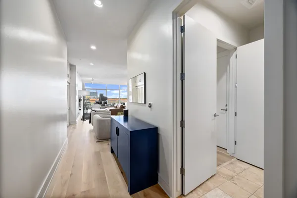 a kitchen with kitchen island granite countertop stainless steel appliances lots of counter space a sink a refrigerator and a stove