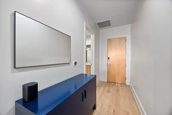 a large living room with stainless steel appliances kitchen island granite countertop a couch and a view of living room