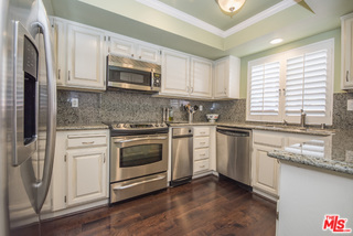 230 Bethany Road, Unit 125 Burbank, CA 91504 - Photo 2 of 3 a kitchen with granite countertop white cabinets and white appliances