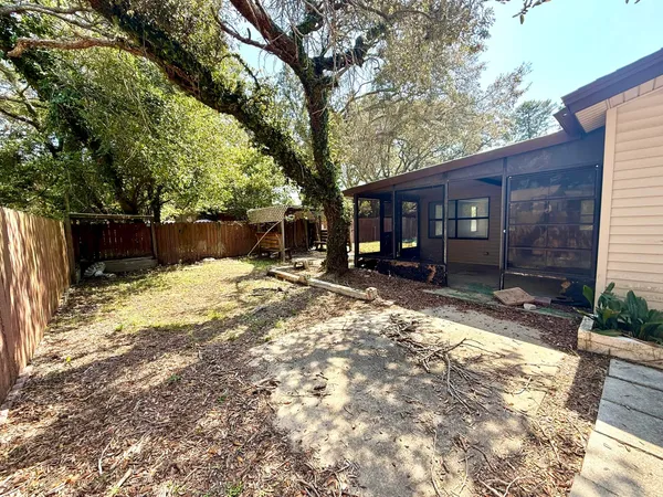 a view of a yard with a tree