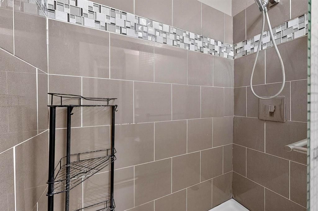 2200 East Trinity Mills Road, Unit 616 Carrollton, TX 75006 - Photo 19 of 34 a bathroom with a shower and a mirror