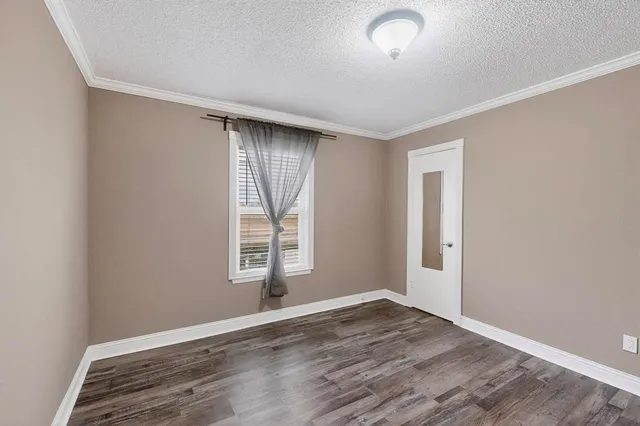 a view of room with window and wooden floor