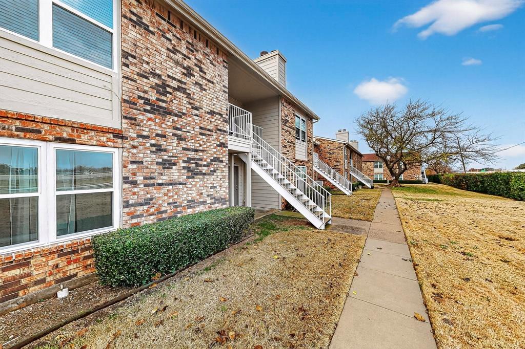 2200 East Trinity Mills Road, Unit 616 Carrollton, TX 75006 - Photo 28 of 34 a front view of a house with a yard