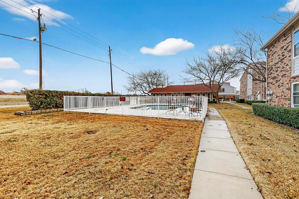 2200 East Trinity Mills Road, Unit 616 Carrollton, TX 75006 - Photo 29 of 34 a view of a swimming pool with a patio