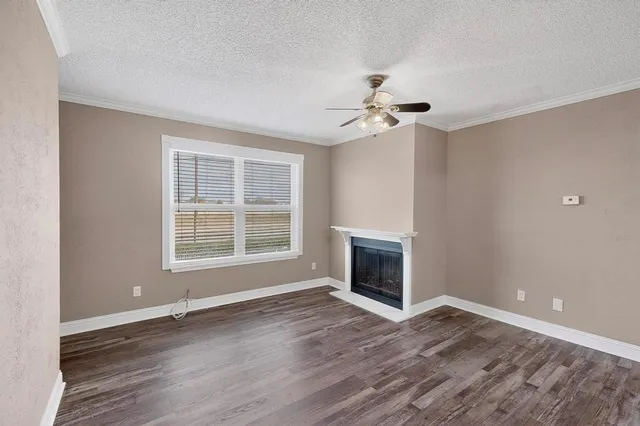 a kitchen with granite countertop a stove top oven and refrigerator