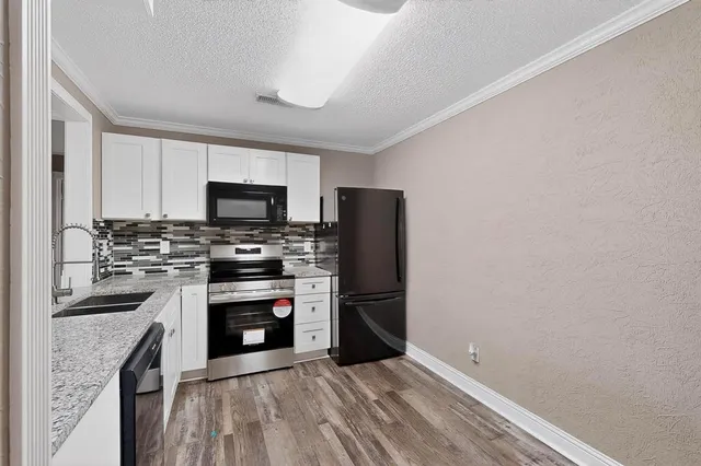 a kitchen with a refrigerator stove and sink