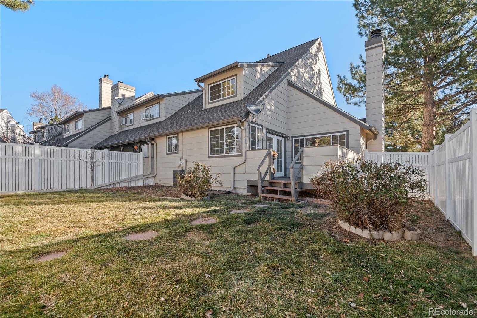 a view of a house with a yard and sitting area