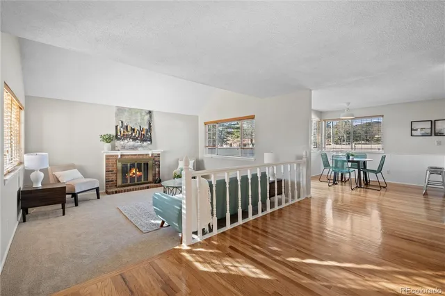 a living room with furniture a fireplace and a table