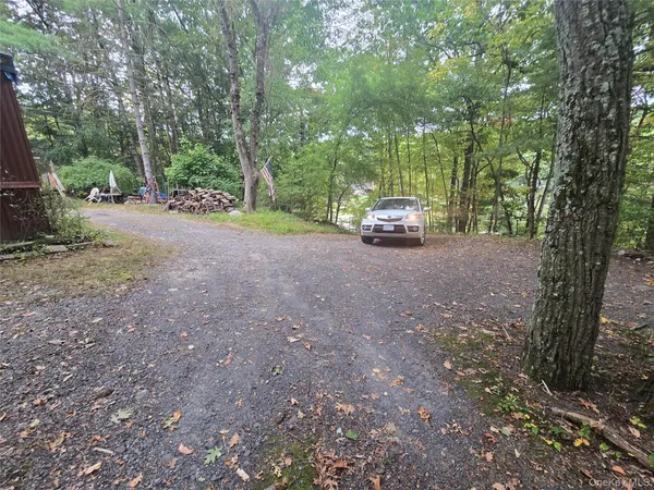 a view of a house with truck parked on a road