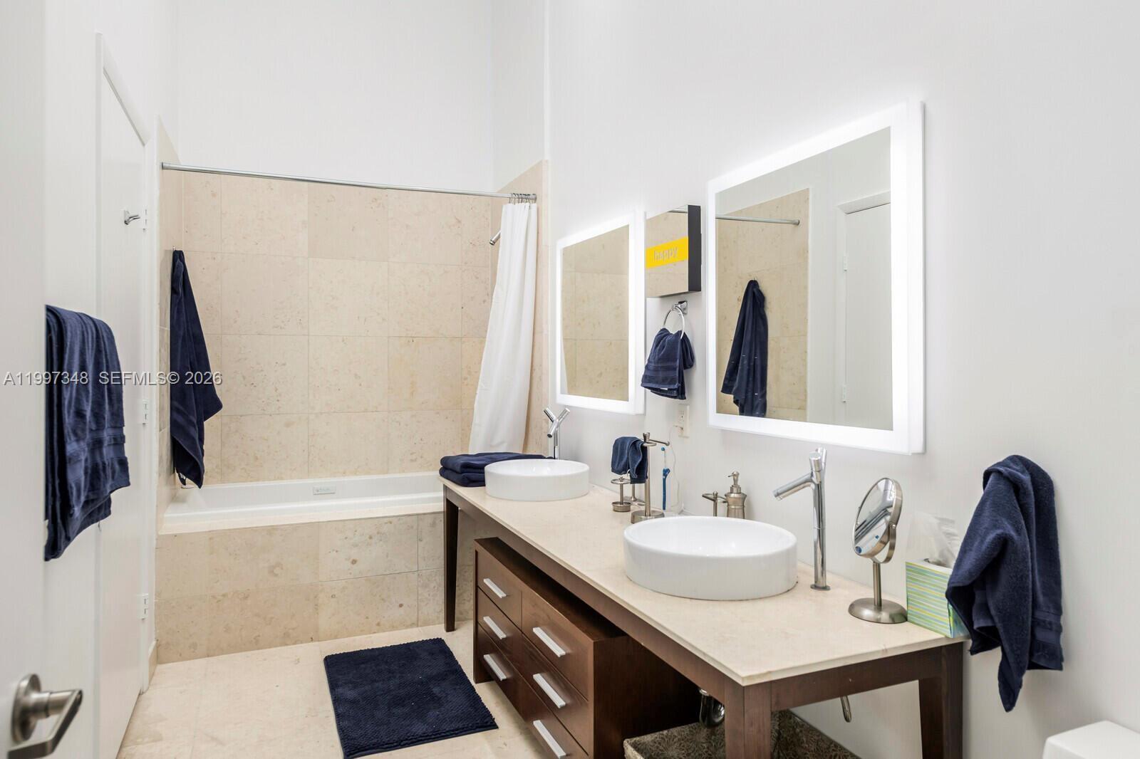 475 Brickell Avenue, Unit 2811 Miami, FL 33131 - Photo 12 of 14 a bathroom with a sink and a mirror