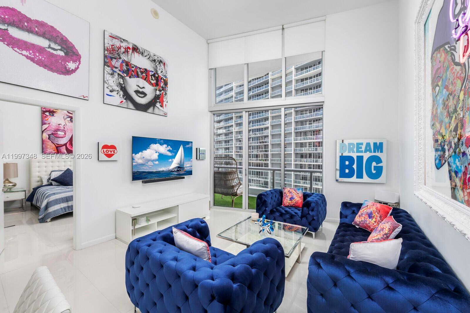 475 Brickell Avenue, Unit 2811 Miami, FL 33131 - Photo 2 of 14 a living room with furniture and a flat screen tv