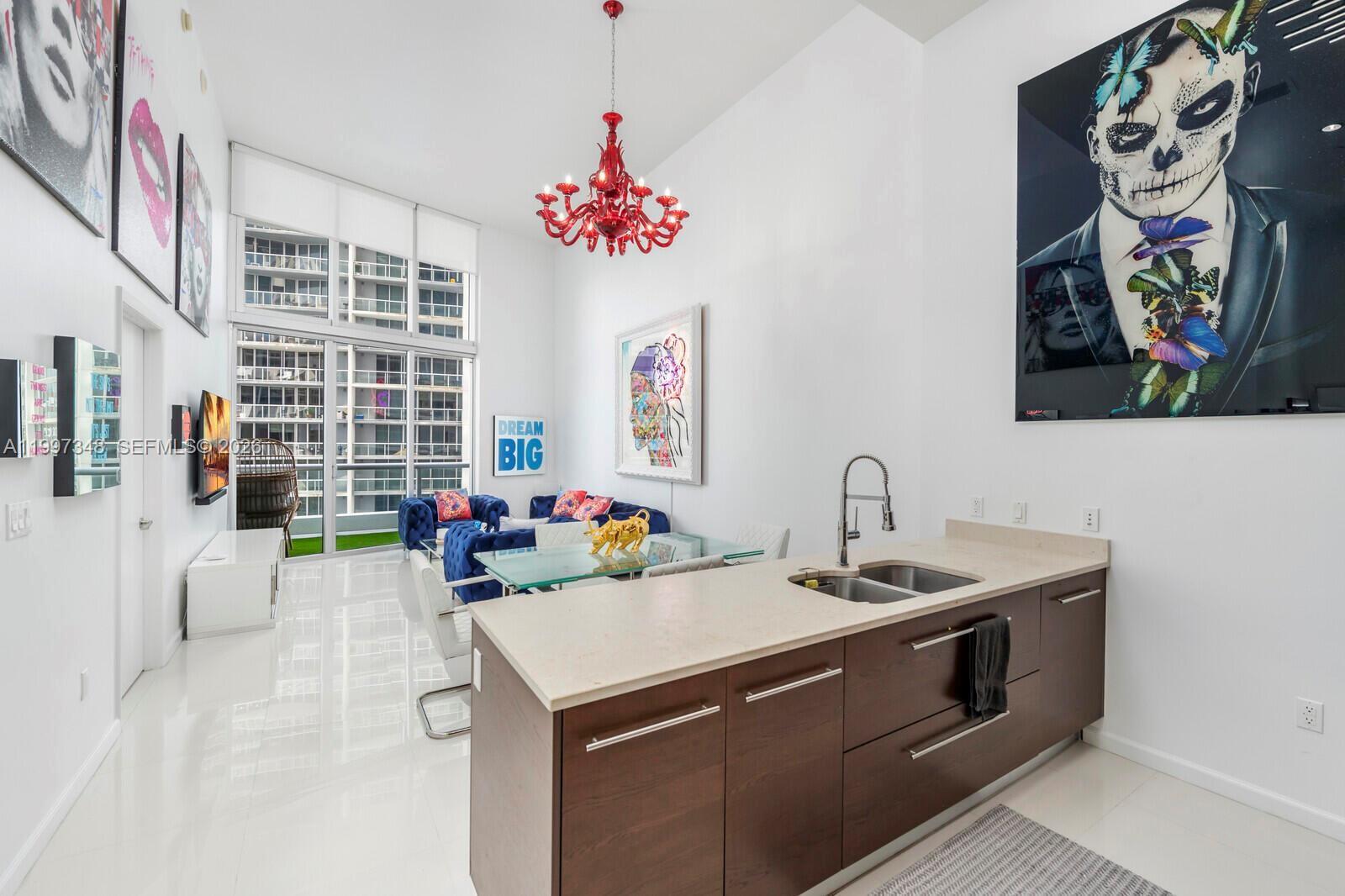 475 Brickell Avenue, Unit 2811 Miami, FL 33131 - Photo 4 of 14 a view of a kitchen with a sink a stove and a chandelier