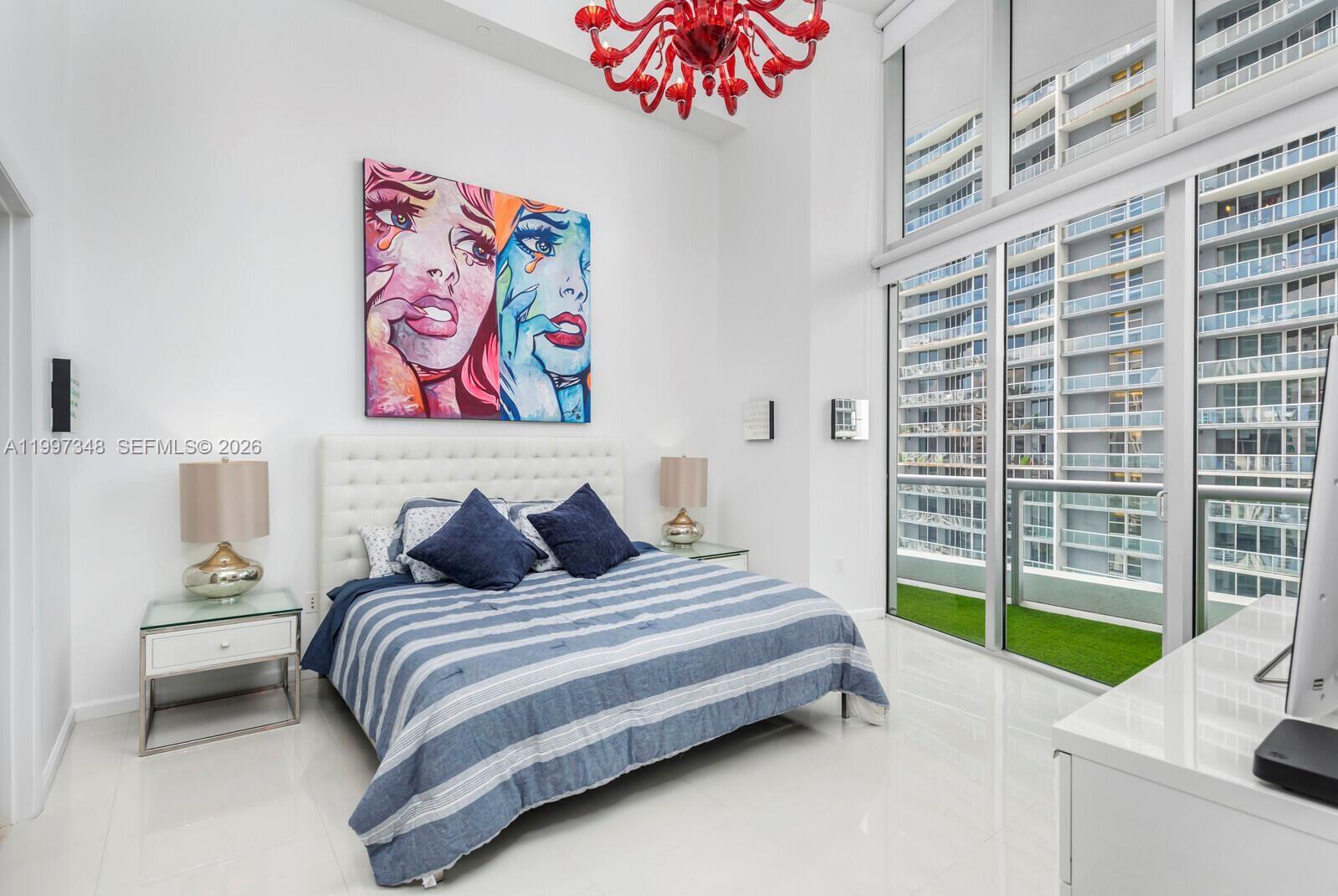 475 Brickell Avenue, Unit 2811 Miami, FL 33131 - Photo 7 of 14 a bedroom with a bed and a painting on the wall