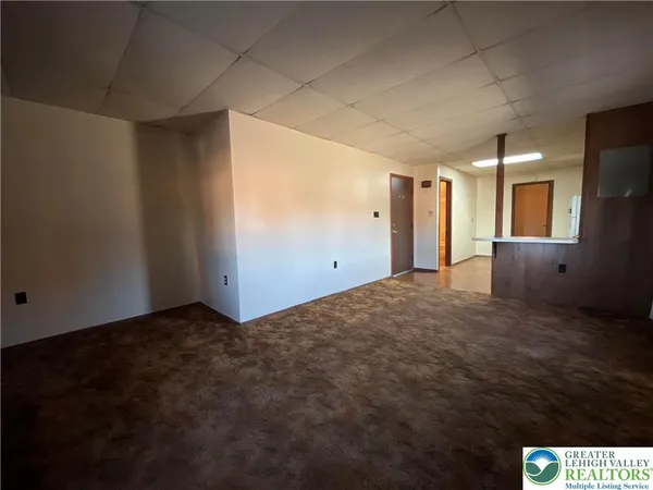 a view of a big room with windows and cabinet