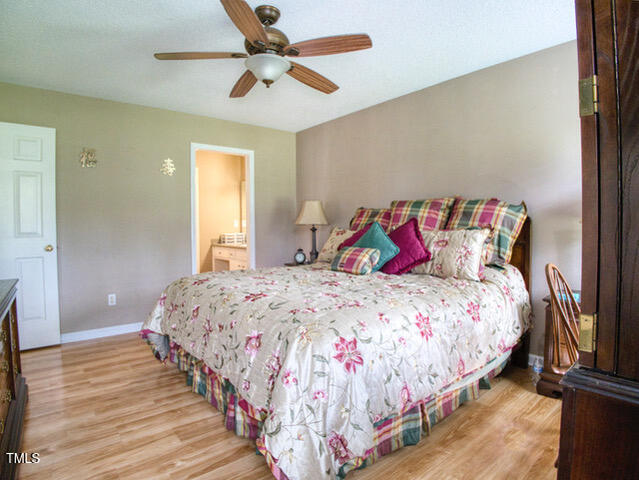 2817 Buckboard Lane Raleigh, NC 27603 - Photo 13 of 31 a bedroom with a bed and a chandelier
