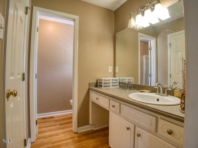 2817 Buckboard Lane Raleigh, NC 27603 - Photo 16 of 31 a bathroom with a granite countertop sink and a mirror