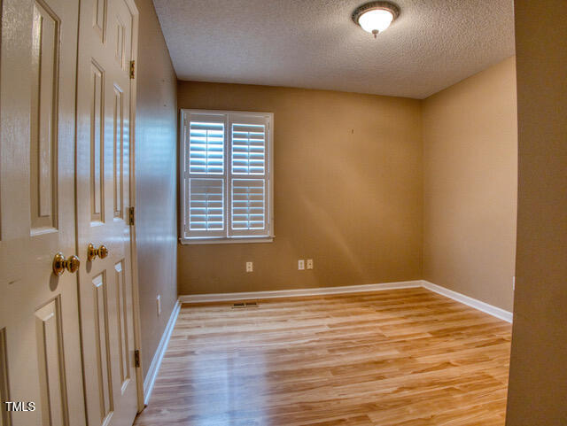 2817 Buckboard Lane Raleigh, NC 27603 - Photo 18 of 31 a view of an empty room with wooden floor and a window