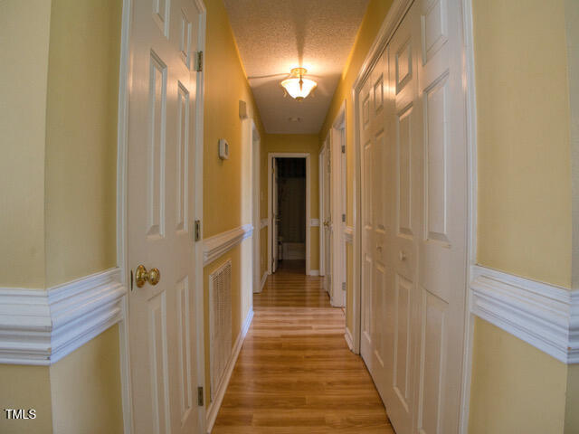 2817 Buckboard Lane Raleigh, NC 27603 - Photo 23 of 31 a view of a hallway with wooden floor