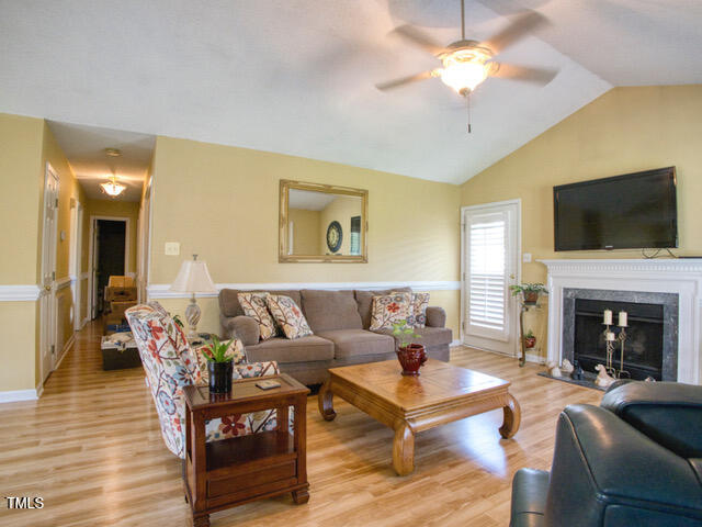 2817 Buckboard Lane Raleigh, NC 27603 - Photo 9 of 31 a living room with furniture fireplace and a flat screen tv