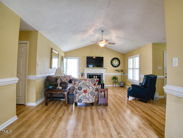 2817 Buckboard Lane Raleigh, NC 27603 - Photo 10 of 31 a living room with furniture and a flat screen tv