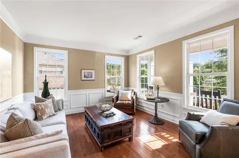 a living room with furniture a flat screen tv and a large window