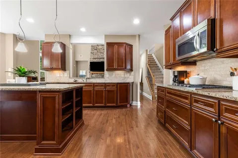 a large kitchen with a table and chairs