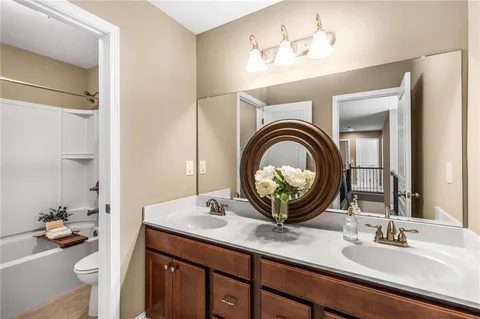 a bedroom with a bed a mirror and a window