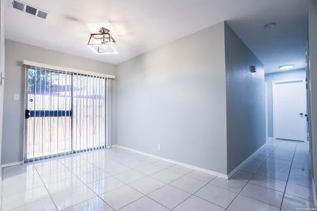 a utility room with cabinets and washer