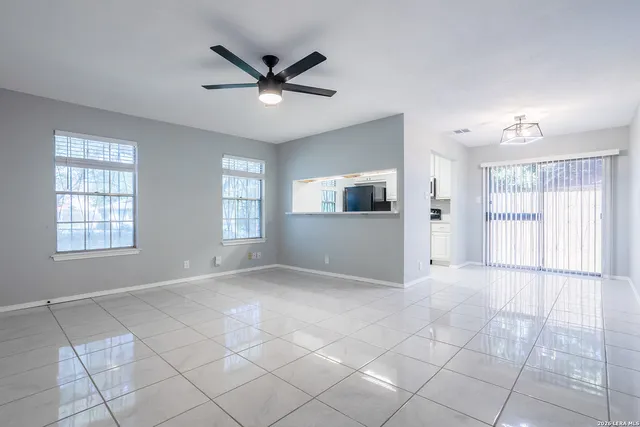 a view of a livingroom with a ceiling fan and window