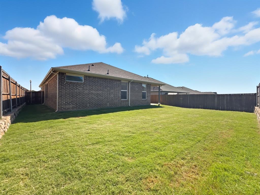 2216 Redwing Drive Denton, TX 76205 - Photo 36 of 38 a front view of a house with a yard