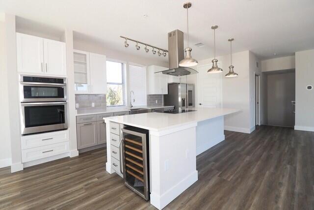 8653 Ivanhoe Drive Melbourne, FL 32940 - Photo 12 of 24 a kitchen with kitchen island stainless steel appliances a stove and cabinets