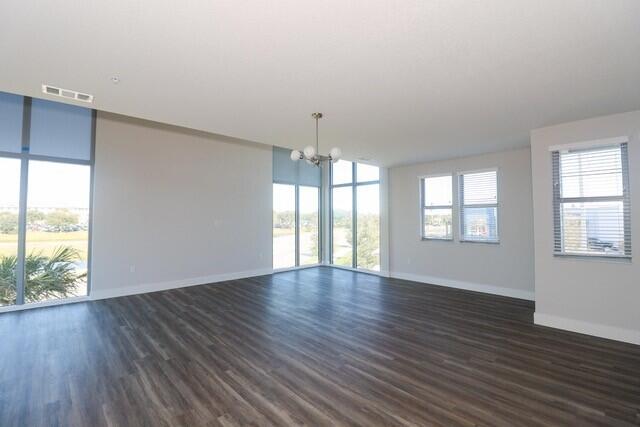 8653 Ivanhoe Drive Melbourne, FL 32940 - Photo 15 of 24 an empty room with wooden floor and windows
