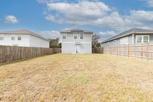 a big house with a large trees in front of it
